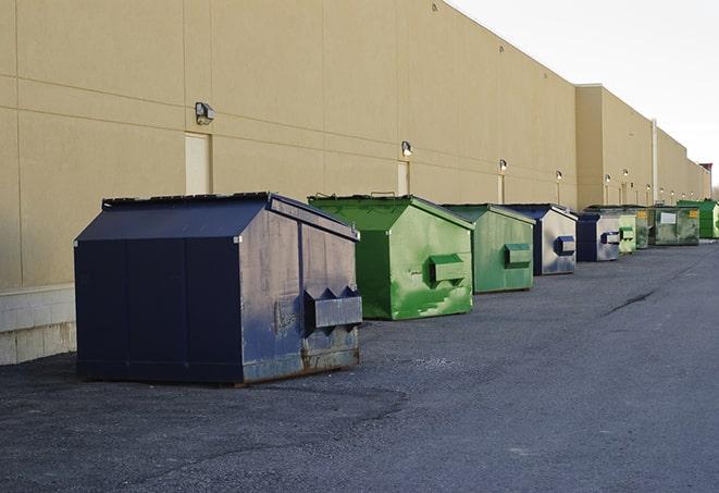 construction workers disposing of debris in large dumpsters in Grulla, TX